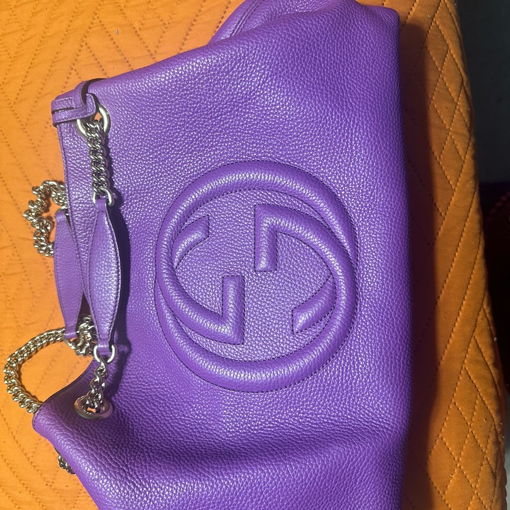 This is a beautiful purple Gucci bag.